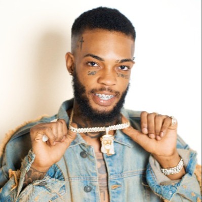 Roze Don wearing a denim jacket and holding his chain